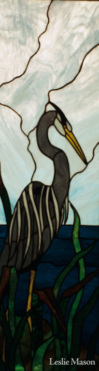 a grey heron in reeds