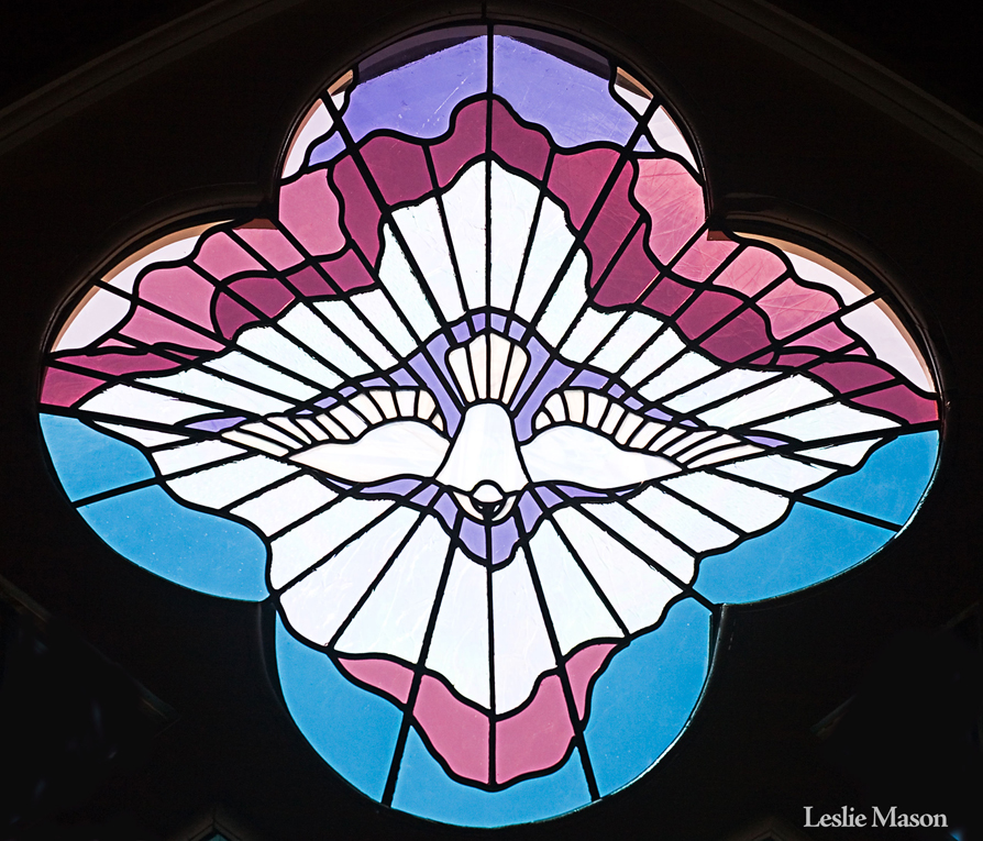 a dove in a central window, with rays extending from it