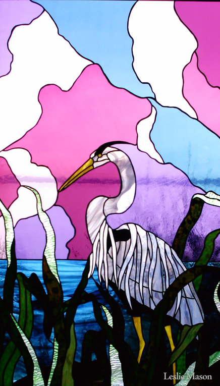 a white crane in tall grass