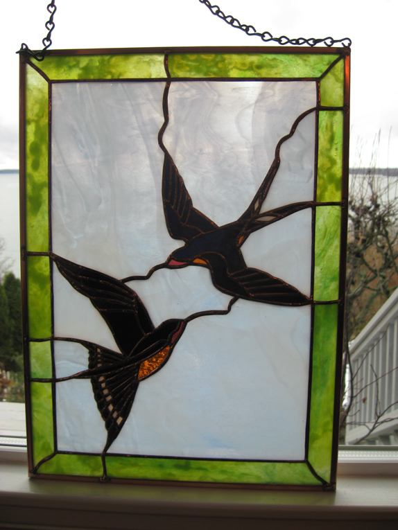 two diving barn swallows