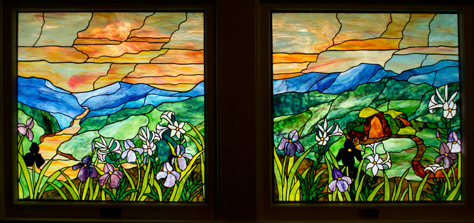 two square windows with blue mountains and orange skies