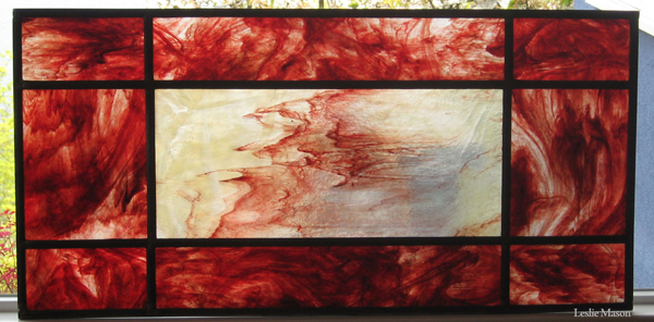 window with rectangular panels containing streaked red glass