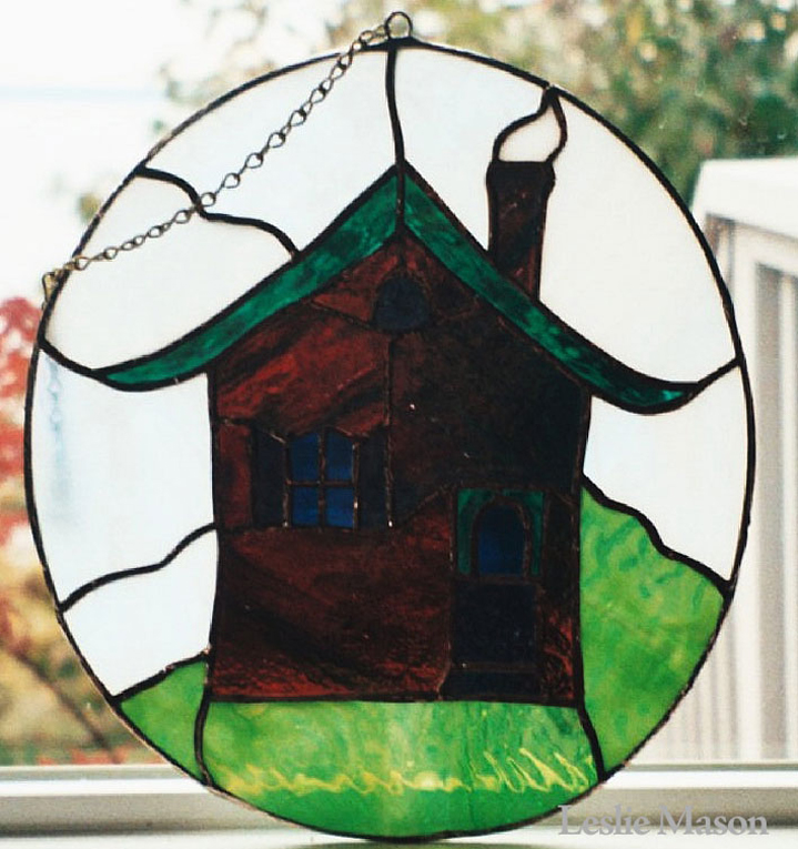 small brown house with green roof